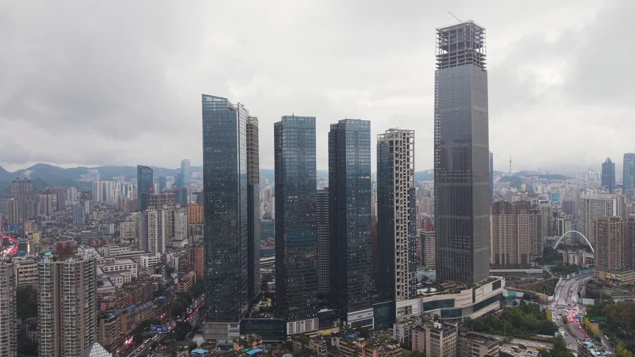 Aerial daytime view of Guiyang, Guizhou Province, showcasing dense urban neighborhoods, modern skyscrapers, and a sprawling cityscape captured in UHD