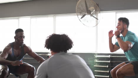 exercising in gym, group of men in activewear engaging in fitness routine