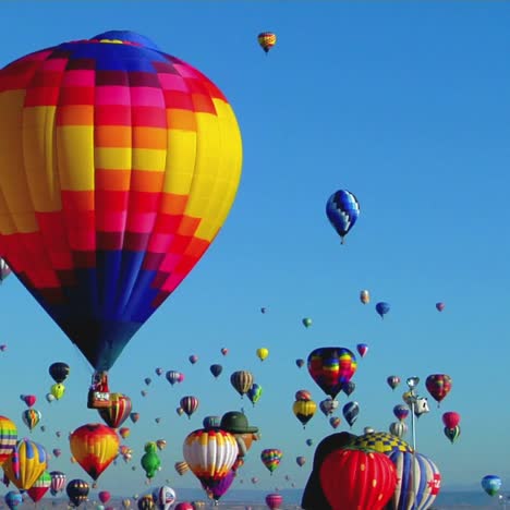 balloons float across the sky at the albuquerque balloon festival 3