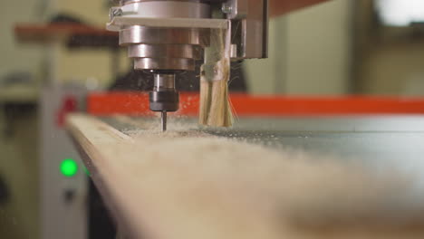 cutting out plywood details with automatic drill at plant