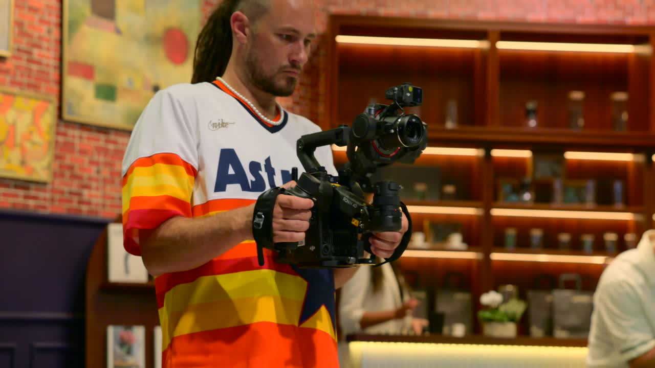 Man Filming With DJI Ronin Camera Stabilization Gimbal At IFA Berlin In Germany. medium shot