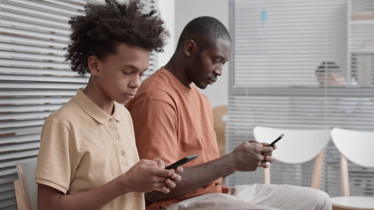 African-American Boy Using Smartphone and Smiling