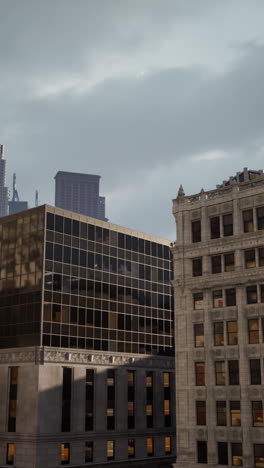 a city skyline with tall buildings and a cloudy sky