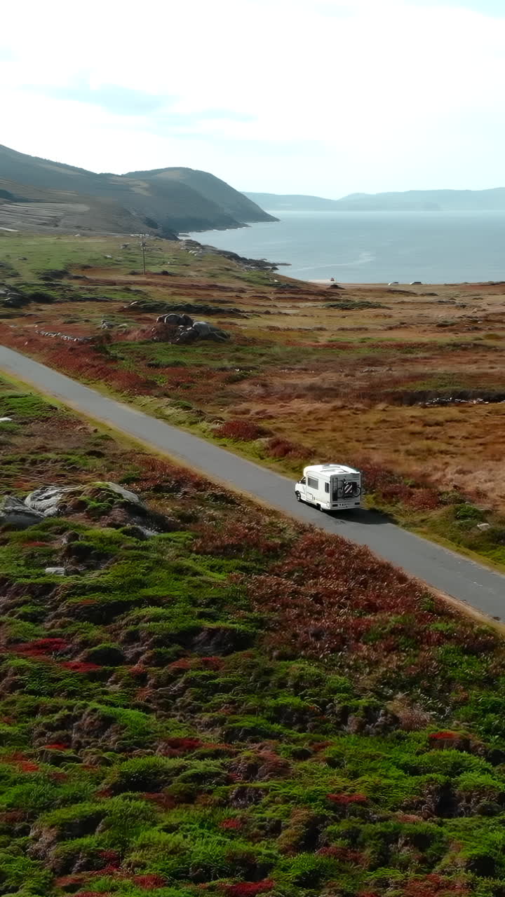 Aerial View of Camper Van Driving on a Scenic Coastal Road