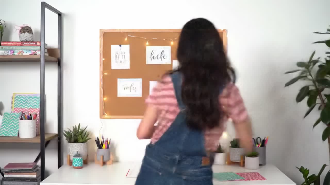 A Creative Workspace with Inspiring Notes and a Focused Individual Engaging in Organization and Planning Activities in a Bright, Inviting Environment