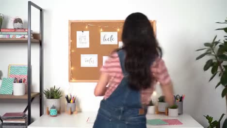 a creative workspace with inspiring notes and a focused individual engaging in organization and planning activities in a bright, inviting environment