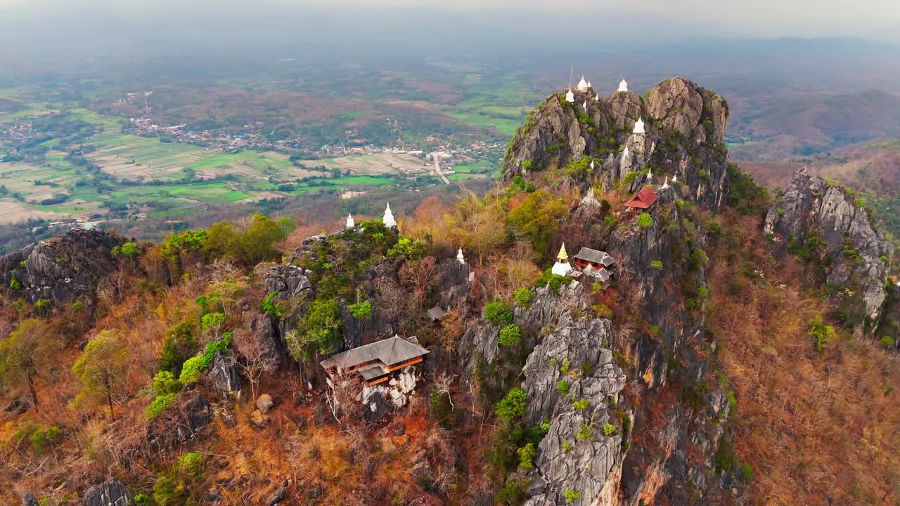 Wat Chaloem Phra Kiat is a Thai temple located on a high mountain. Drone orbit.