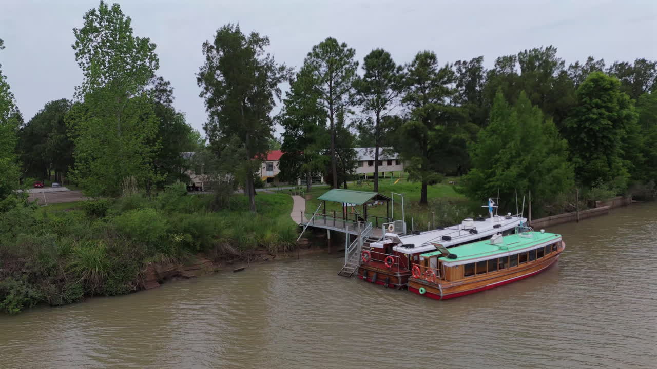 Boats on a river with kids being brought to school, capturing a peaceful morning routine.