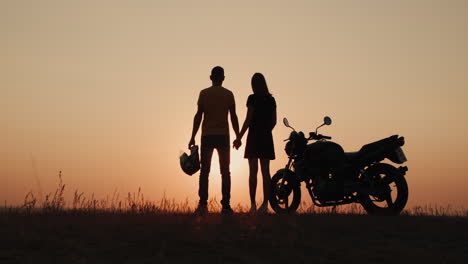 romantic pair of bikers at sunset