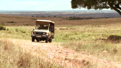 A-safari-vehicle-travels-across-the-plains-of-Africa