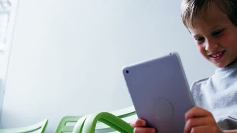 Boy-using-digital-tablet-in-hospital-corridor