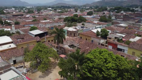 low aerial flyover of san salvador city low rise tiled roof tops