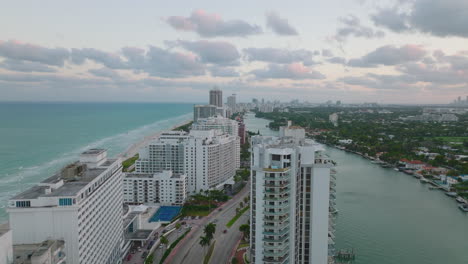 Modern-high-rise-residential-towers-along-highway-in-coastal-urban-borough.-Luxury-apartment-buildings-at-seaside.-Miami,-USA