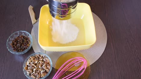 making cake batter, sifting flour to make it more airy