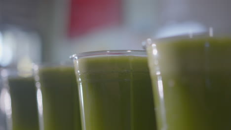 close up of a row of green juices