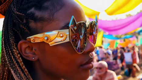 woman at a festival wearing unique sunglasses