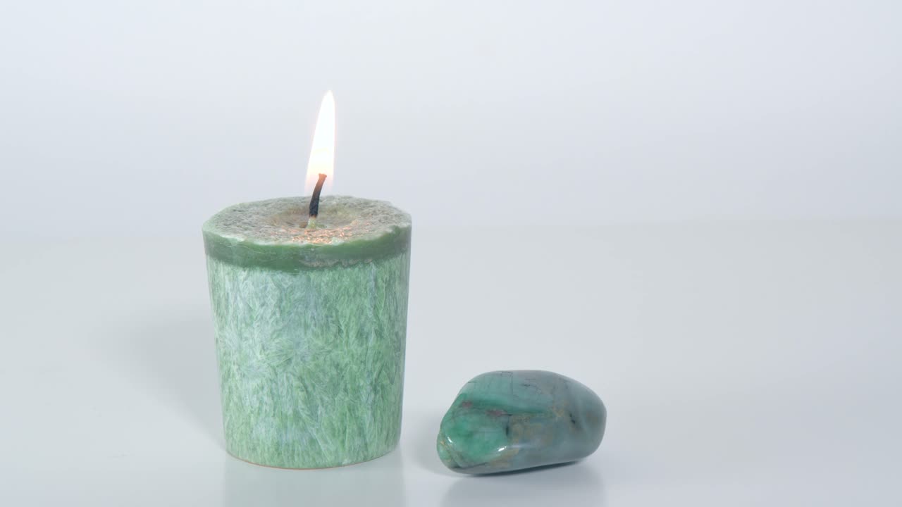 Green heart chakra candle with emerald