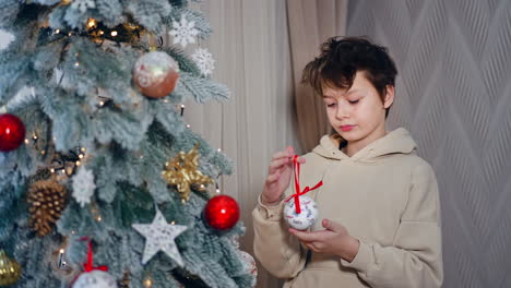 boy decorating christmas tree