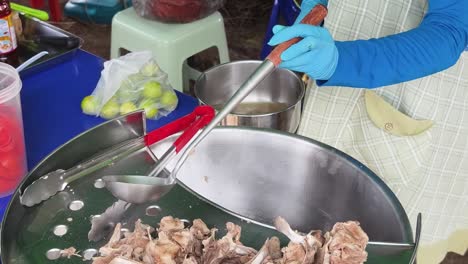 street food vendor preparing pork soup