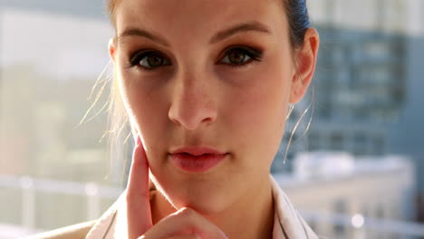 Pretty-businesswoman-thinking-and-looking-at-camera