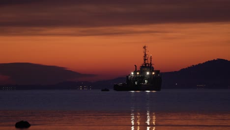 slow zoom on bsad ailette french support ship anchored at sunset