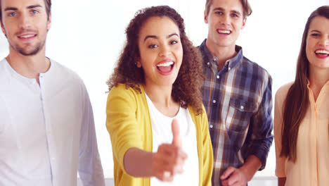 Portrait-of-smiling-executives-showing-thumbs-up