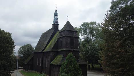 old-medieval-catholic-church-wooden-construction-in-tree-aerial-dolly