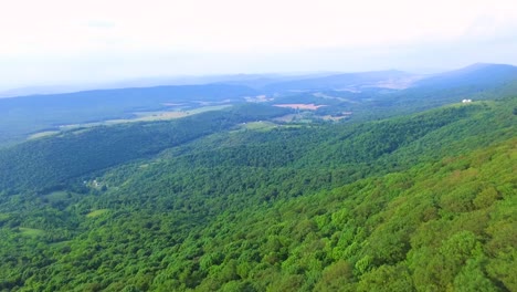 Aerial-over-mountain-range-flying-toward-valley