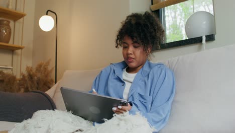 woman using digital tablet at home