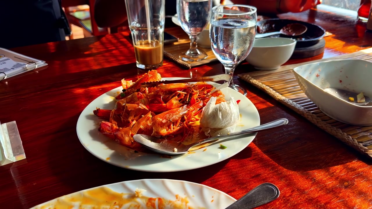 Seafood feast with prawns and rice served on a sunlit restaurant table
