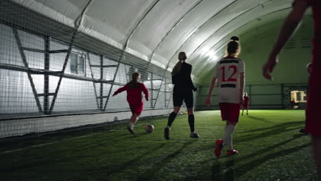 young girls playing indoor soccer