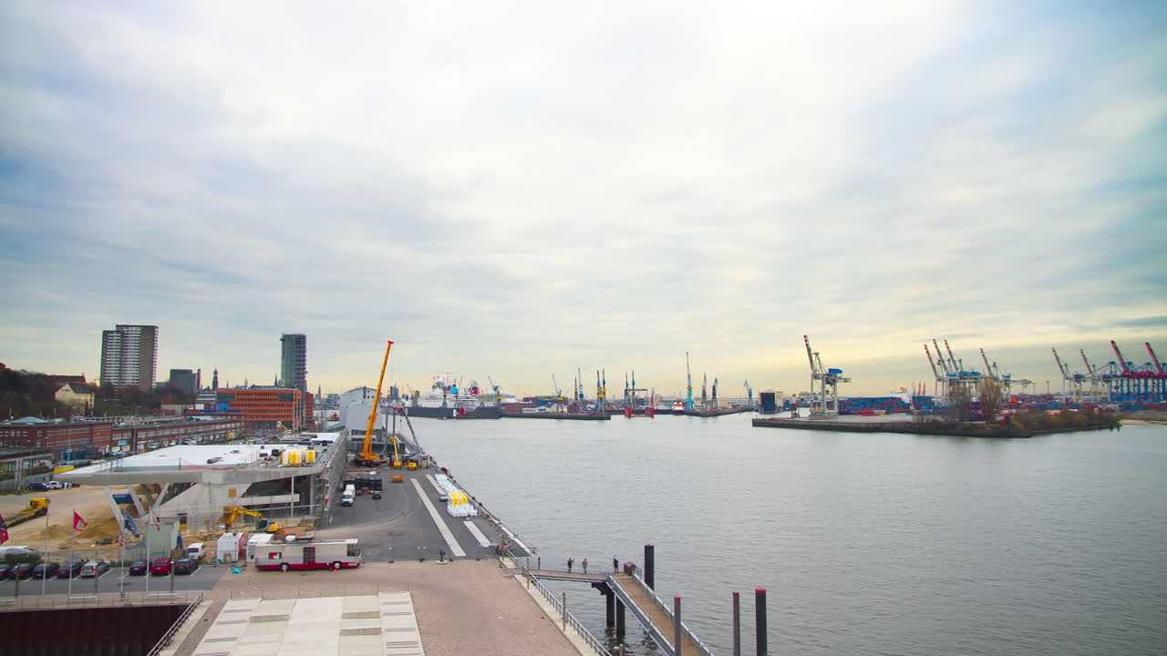 beautiful time lapse long shot of the port of Hamburg with many ships and a huge container ship
