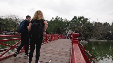 people walking on the huc bridge, hanoi