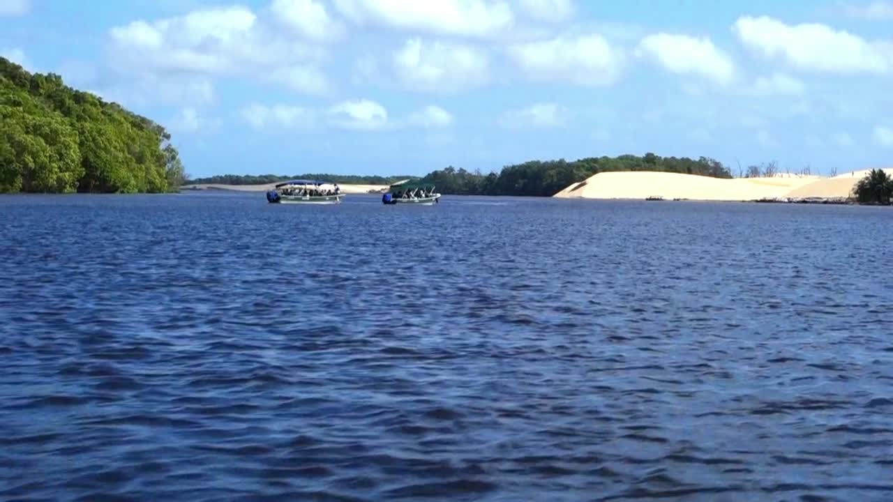 Aerial fast dolly shot of beautiful tropical beach on blue river. flying over the river, low attitude close to the beach. Aerial Drone Shot Of Glamorous river.