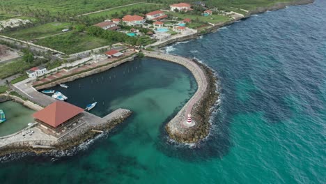 drone camera movement, orbit and pan in a medium shot over the restaurant and the lighthouse