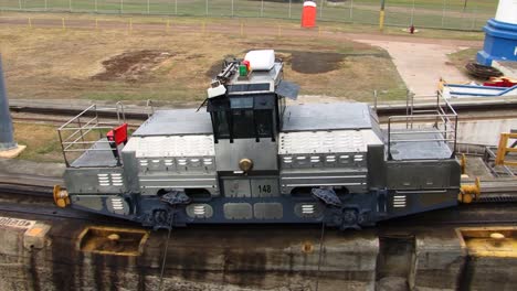 starboard side electric locomotive pulling the ship at gatun locks, panama canal