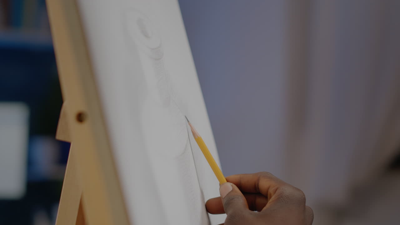Close up of african american hand of artist holding pencil