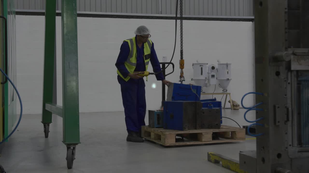 Warehouse tech operating jack and pendant, lifting load as network overlay growing for monitoring