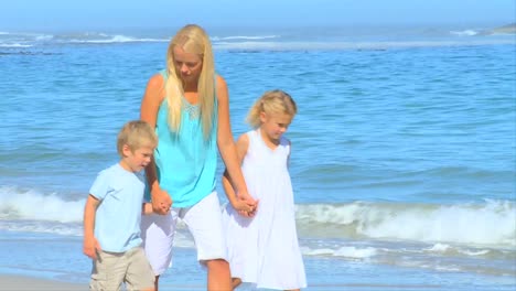 mother on the beach with her young children