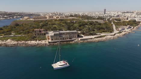 An-aerial-view-of-Maneol-Island-in-Marsamxett-Harbour,-Malta