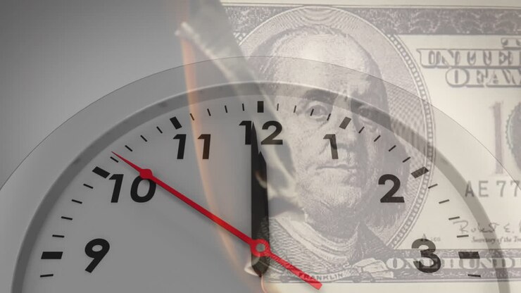 Animation of clock ticking over burning american dollar currency banknote