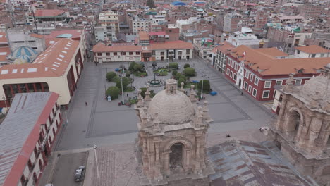 drone shot above plaza mayor de puno peru near the church or cathedral log