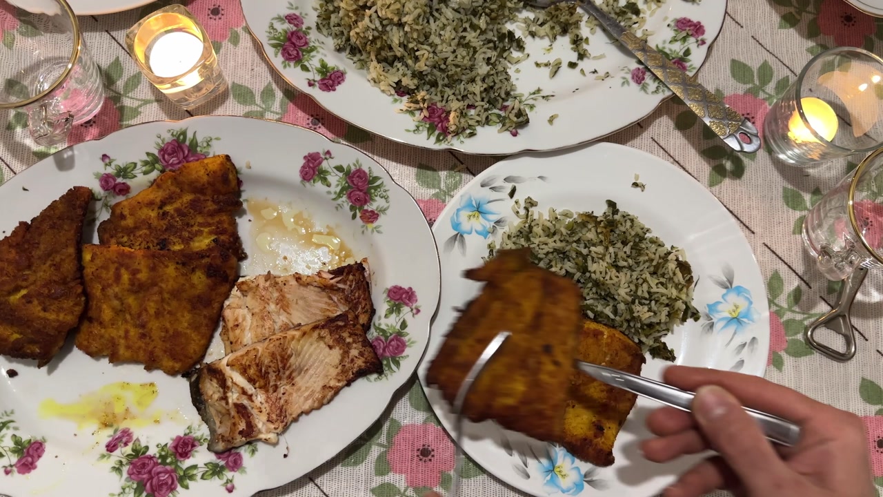 Serving local food in Persian New Year dinner party with family gathering eating fried fish steamed rice on fancy Nowruz table seasoning herbs spices crispy homemade gourmet tasty healthy meal in Iran
