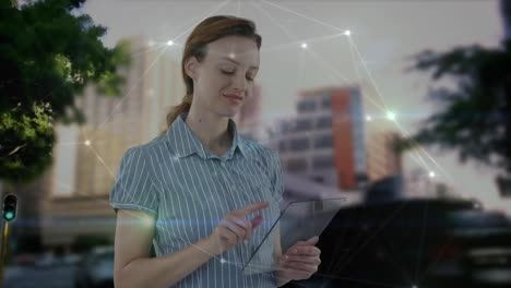 Animation-of-caucasian-businesswoman-using-tablet-and-network-of-connections-over-cityscape