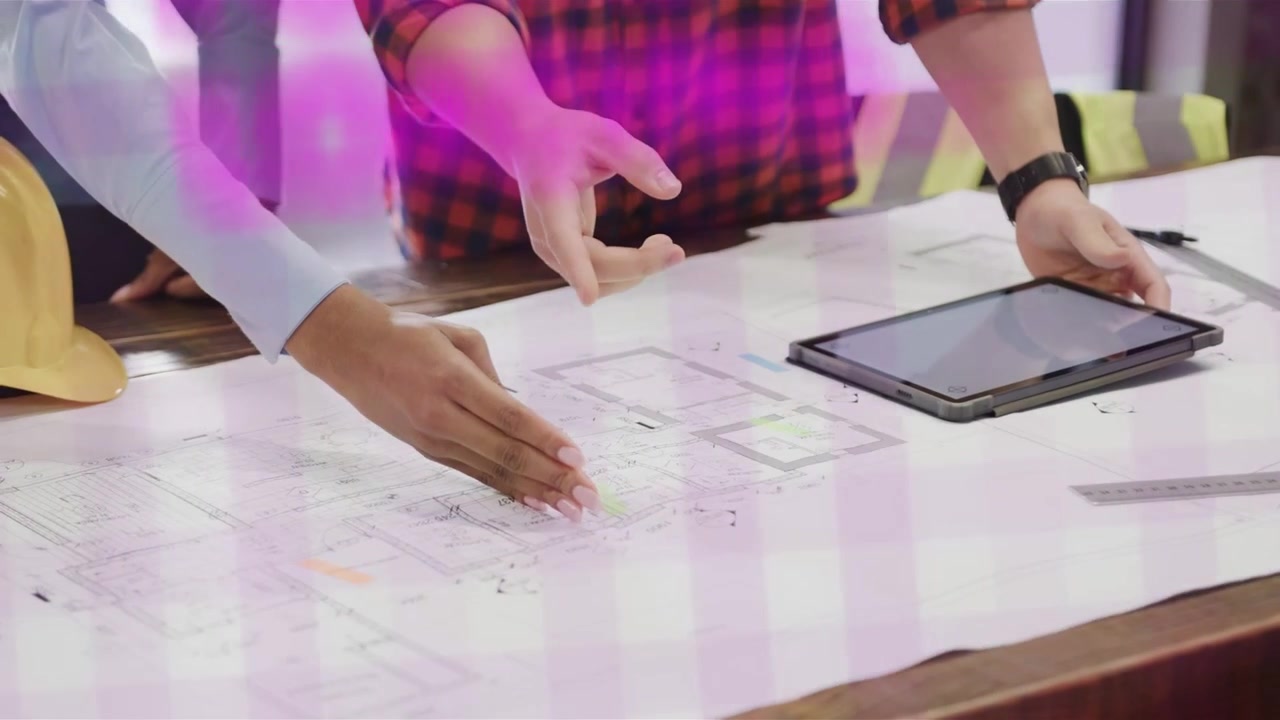 Vertical video: Magenta grid sliding two pros in blue, plaid tops reading desk plans, moving tablet