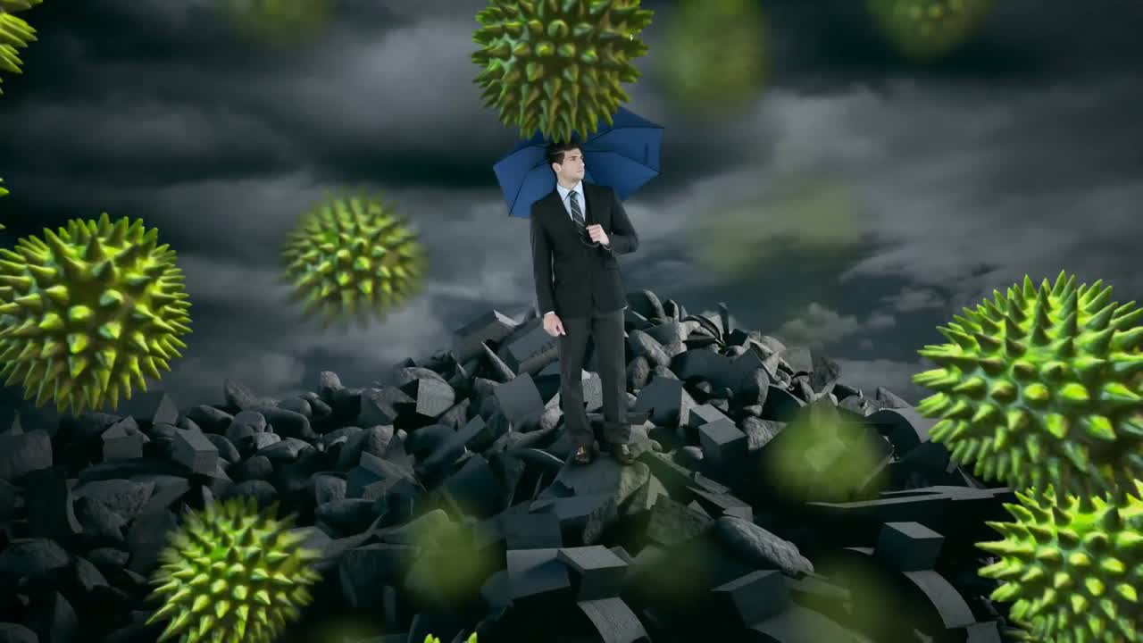 Multiple covid-19 cells floating over businessman holding an umbrella standing on broken rocks