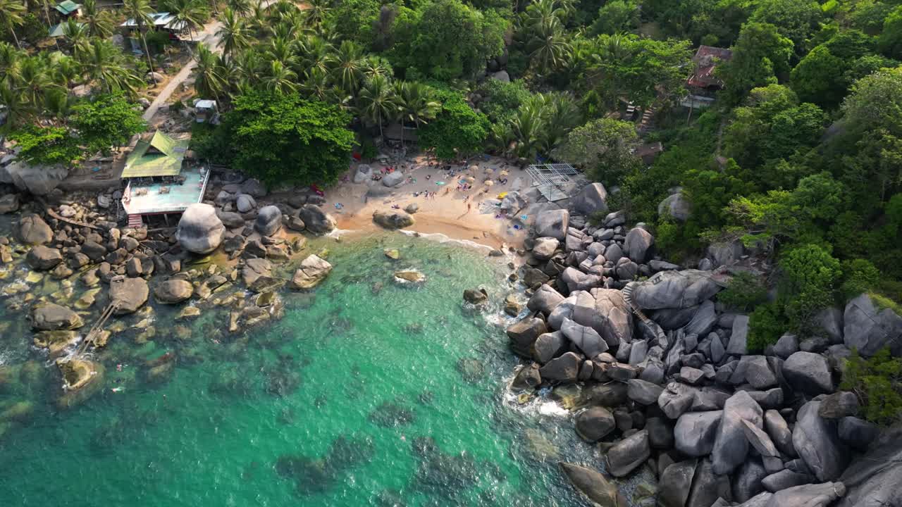 Stop-motion drone hyperlapse over stunning hidden tropical beach with people