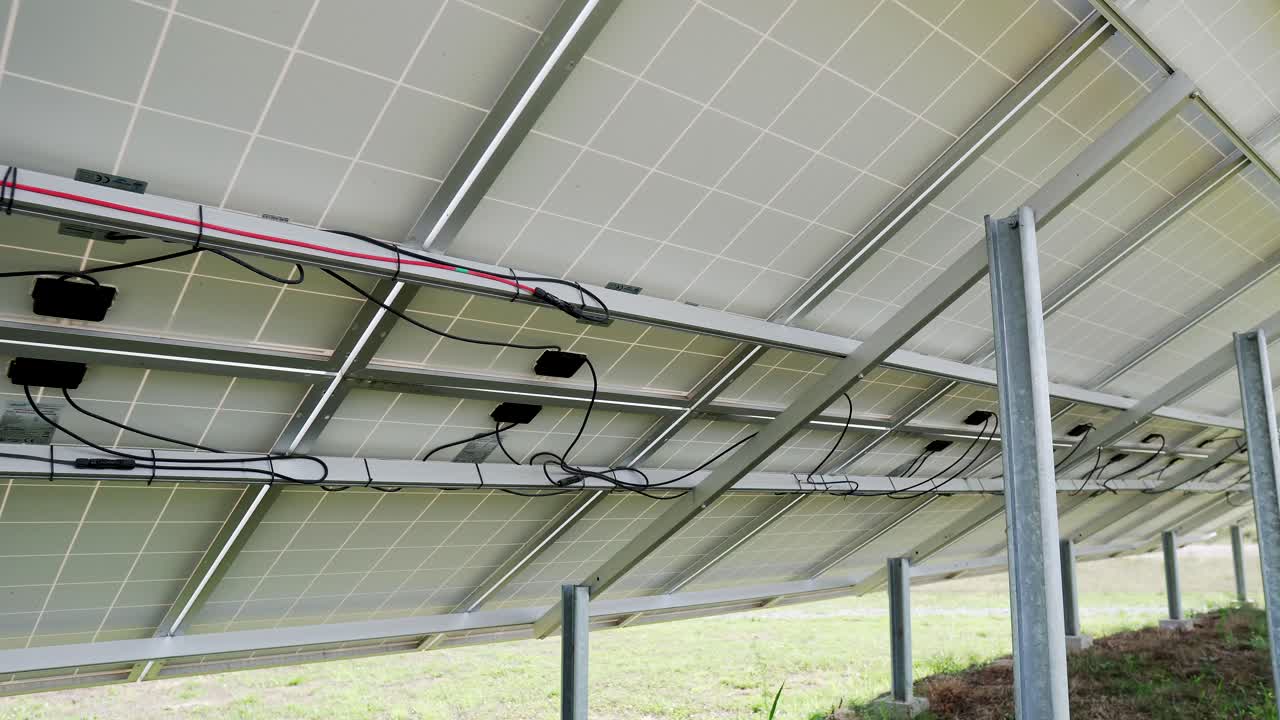 back side view rows array of polycrystalline silicon solar cells or photovoltaics in solar power plant