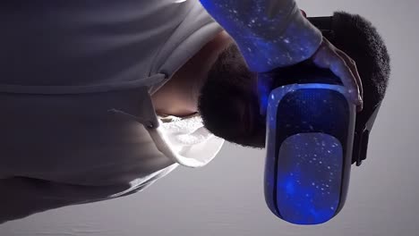 Man-holds-on-to-VR-headset-goggles-with-one-hand,-immersive-experience