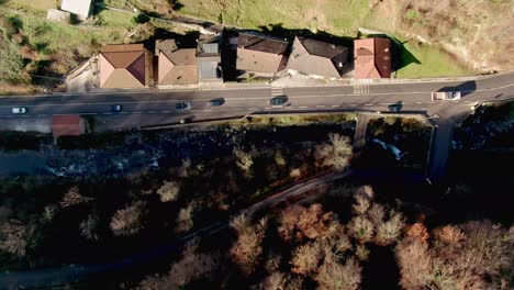 drone angled straight down captures cars on a road, highlighting motion and geometric symmetry